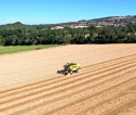 Aerial view of a machine ploughing a field.